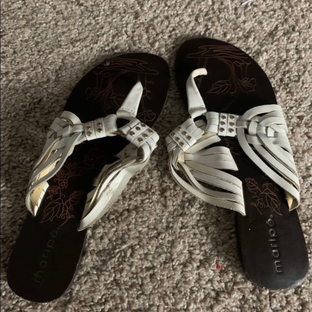 White sandals with gold buttons